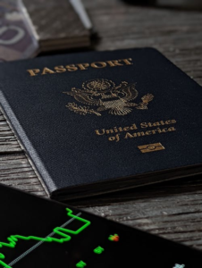  US passport is placed on a table with a graph placed below.