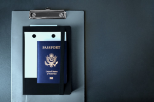 n American passport on top of a clipboard and a diary