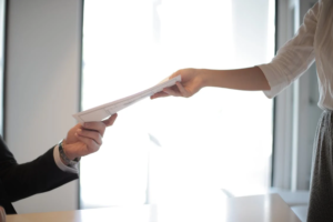 A person handing documents for immigration 