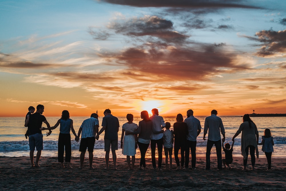 a large family standing at the beach