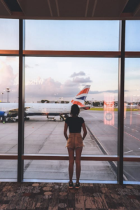 A person standing in front of a window