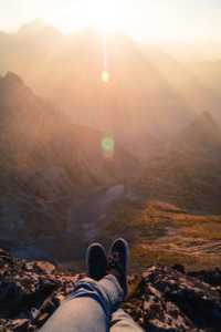 A person relaxing by a cliff