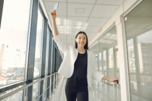 A woman showing her passport excitedly