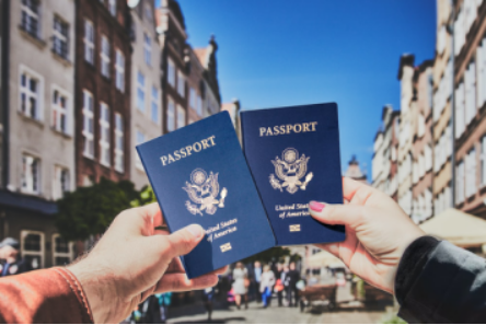 two people holding passports together