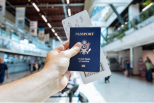 a person holding a passport and a ticket