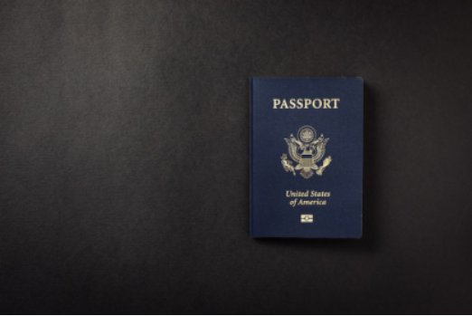 an American passport on a black surface