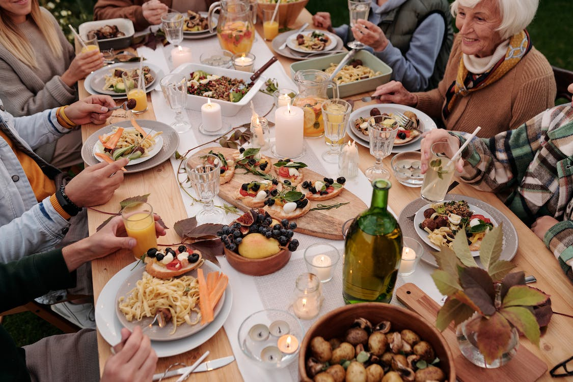 A family enjoying a meal together at a long dining table