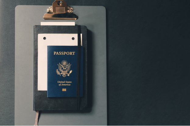 A photo showing a passport resting on top of a folder.