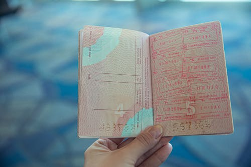 A person holding an opened passport
