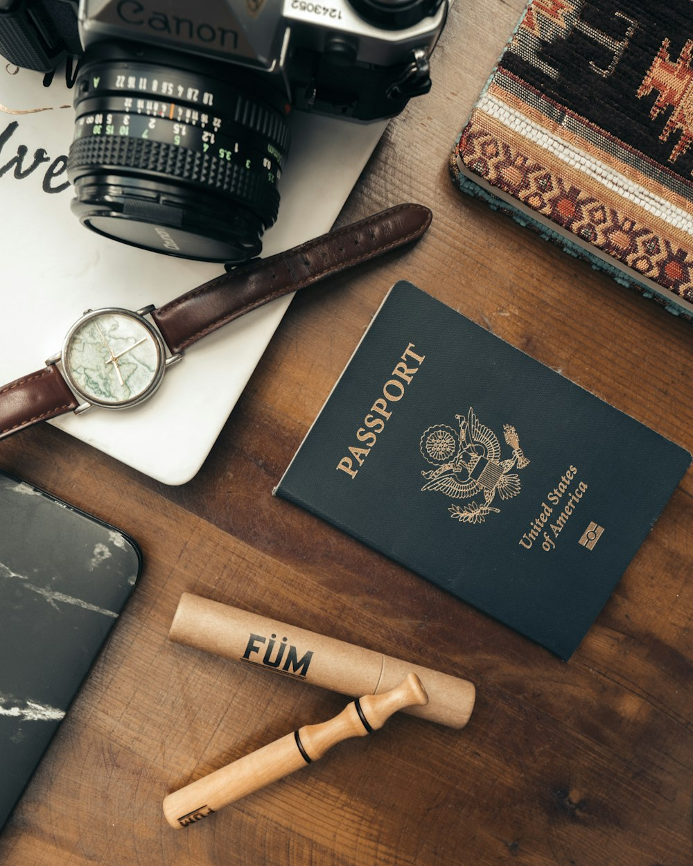 American passport, watch, camera, and travel essential