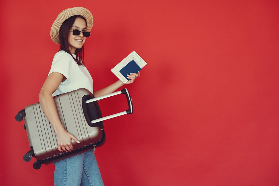 A happy traveler with an urgently renewed passport and luggage bag