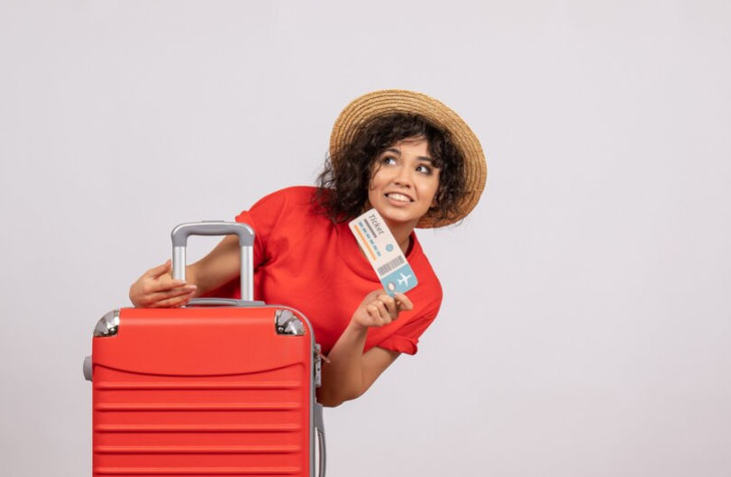 A woman holding a plane ticket.