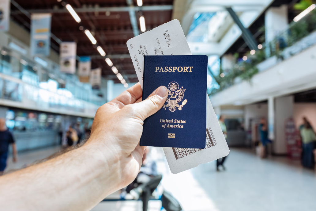 A person holding a passport with a boarding pass.