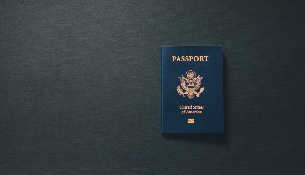 An online expedited passport on a dark surface.