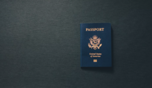 An online expedited passport on a dark surface.