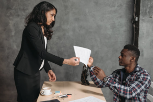 A person handing over documents for expedited passport services.