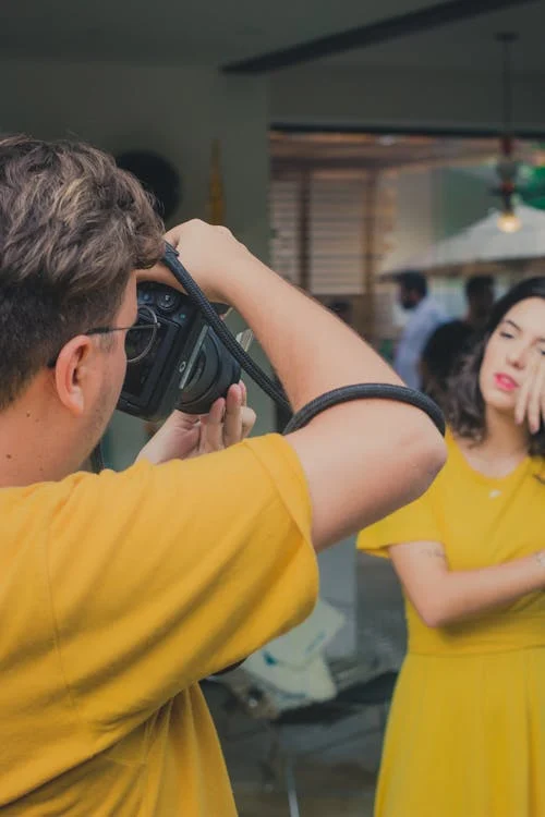 A person getting a passport photo taken.