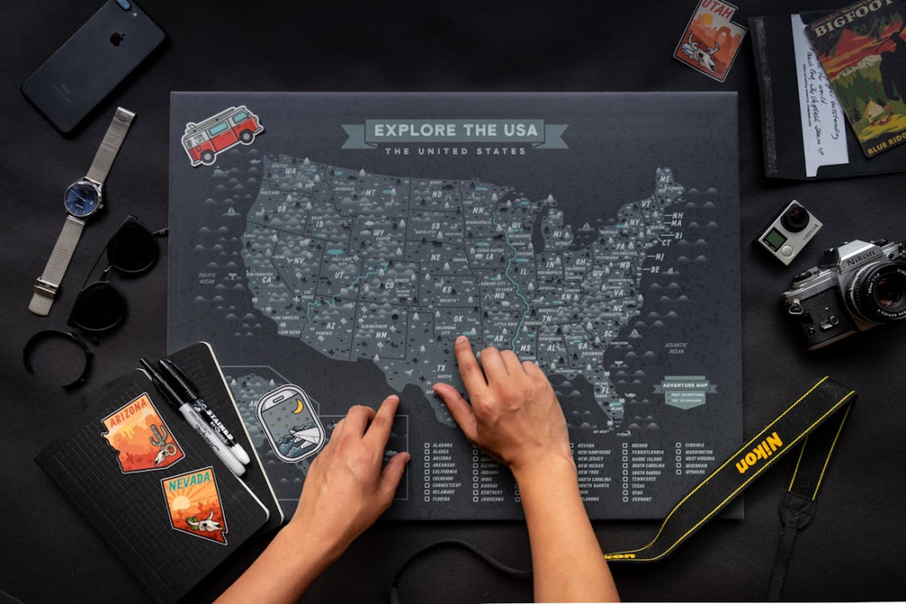 A person tracing their fingers on a USA map.