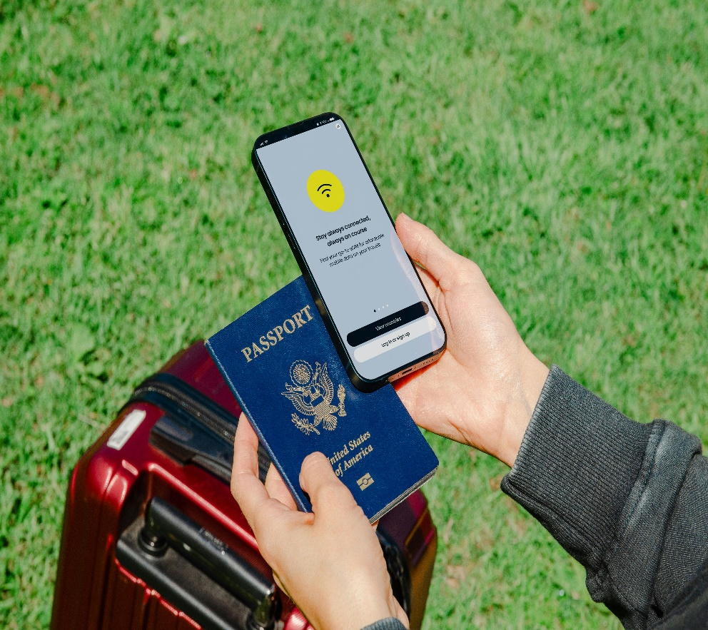 A person holding their phone and passport. 