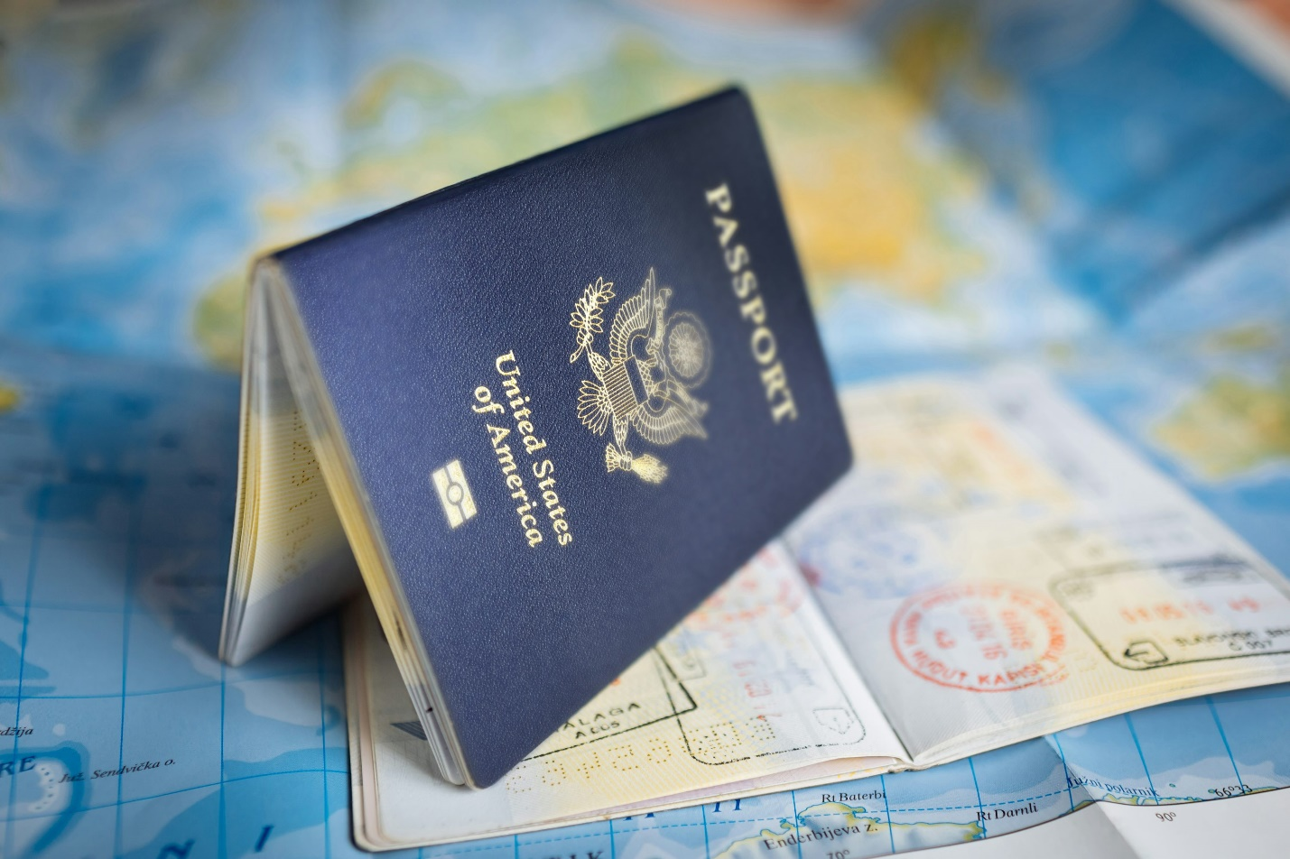 two American passports placed on a world map