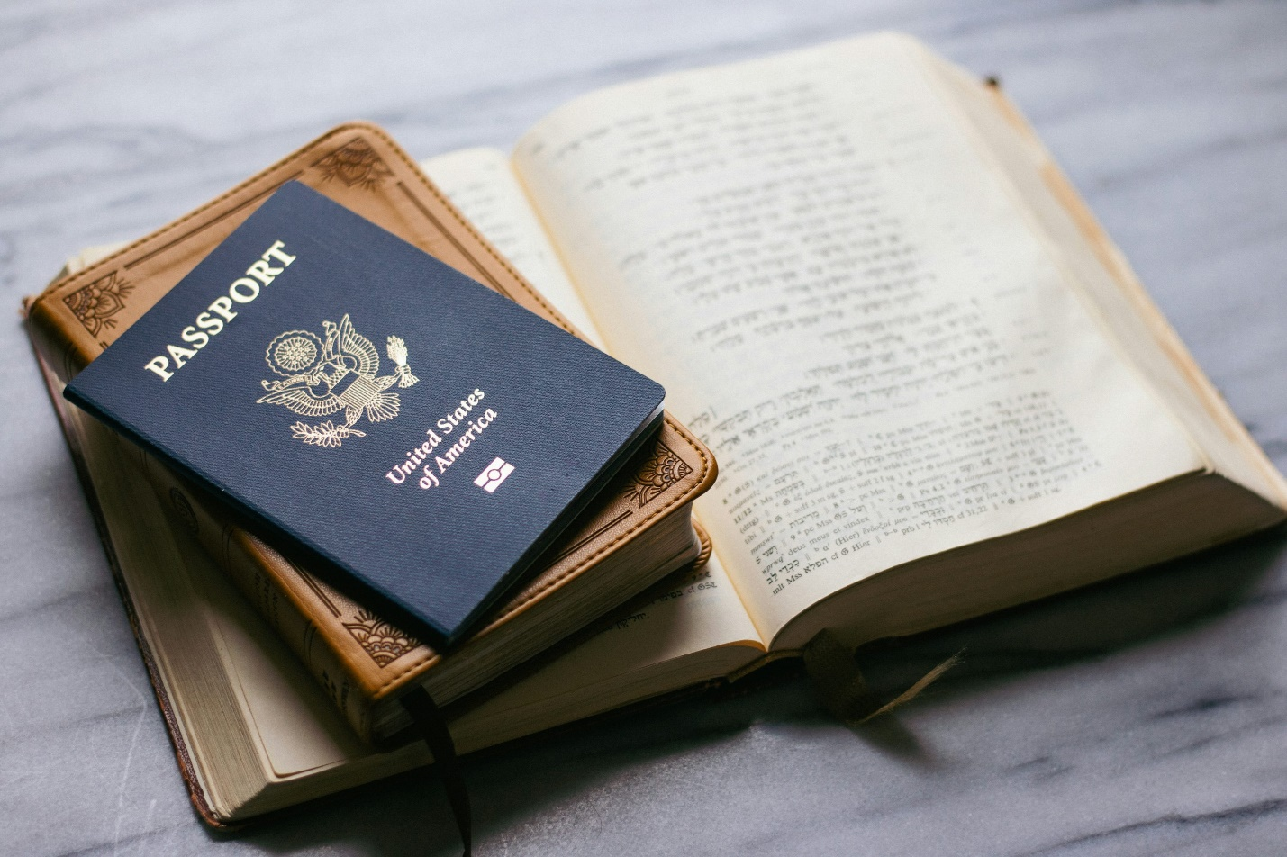 a passport placed on top of a few books