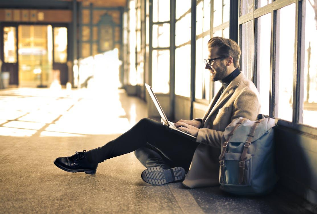 A professional man in a gray blazer, ready for business travel with an emergency expedited passport.